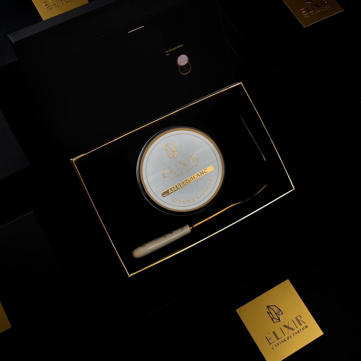 The Amber Blanc box open, the white tin seated inside beside its spoon