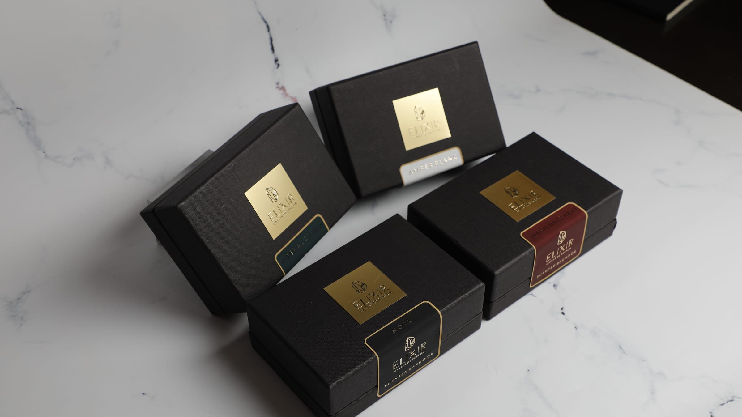 The four Caviar Bakhoor boxes on white marble
