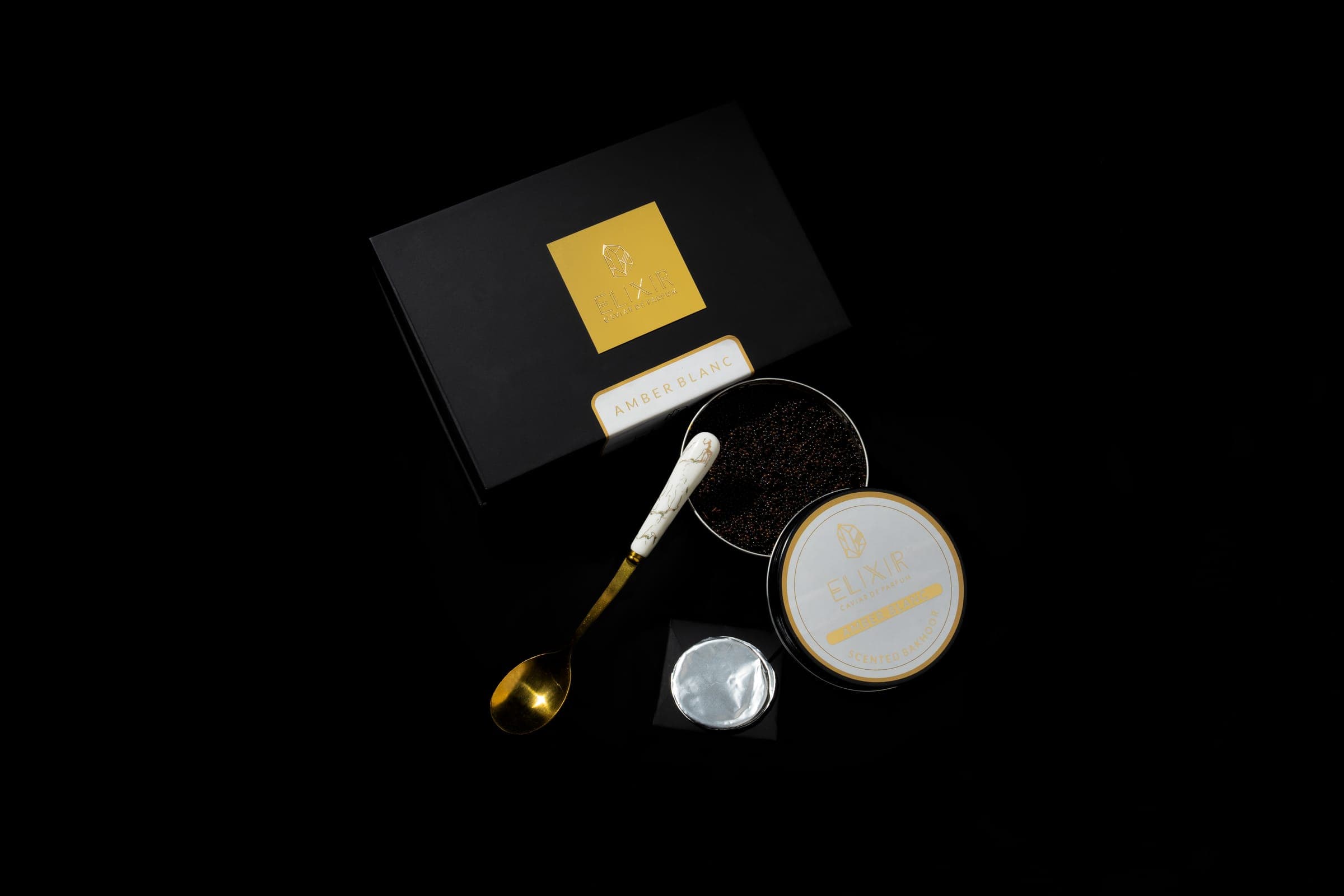 The Amber Blanc kit: the box, the open tin, the spoon and a disc of foil